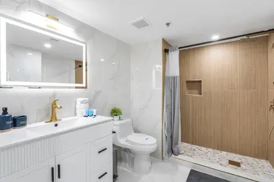 a bathroom with a toilet and a sink and a shower at Enjoy Pool and Stunning City Views in Brickell in Miami