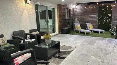 a patio with couches and chairs and a table at Canal Views from Pool w BBQ and Pit Miami Escape in Kendale Lakes