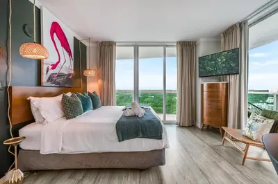 a bedroom with a large bed and large windows at Elegant 2BR Condo at Hotel Arya Full Kitchen Wraparound Views 2 Parking Spots in Miami
