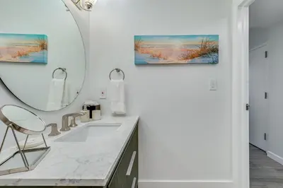 a bathroom with a sink and a mirror at Stylish Studio King Bed City View Hotel Perks Parking in Miami