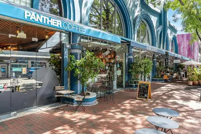 a market with tables and chairs in front of a building at Bright 1BR in Coconut Grove King Bed Views Pool and Parking in Miami