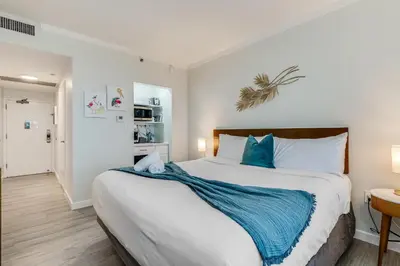 a bedroom with a large bed with blue pillows at Modern 3BR 3BA Grove Condo Views Balconies Full Kitchen 3 Parking in Miami