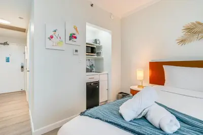 a bedroom with a bed with a towel animal on it at Modern 3BR 3BA Grove Condo Views Balconies Full Kitchen 3 Parking in Miami