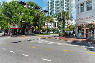 an empty street with a traffic light in a city at Cozy Grove Stay Free Parking Pool Access Walk to Cafes and Parks in Miami