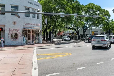 a city street with cars driving down a street at Cozy Grove Stay Free Parking Pool Access Walk to Cafes and Parks in Miami