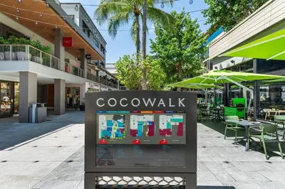 a sign for aocowalk on a city street at Cozy Grove Stay Free Parking Pool Access Walk to Cafes and Parks in Miami