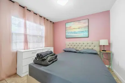 a bedroom with a bed and a window at La Casa Flora Private PoolHot tubSleeps 18 in Miami