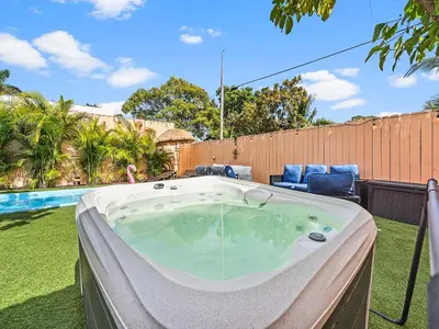 a jacuzzi tub in a yard next to a pool at Villa Bonita 6BR Pool Hot Tub Game Room in Miami