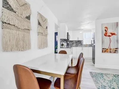 a white dining room with a white table and chairs at Villa Bonita 6BR Pool Hot Tub Game Room in Miami