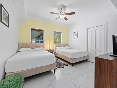 a bedroom with two beds and a ceiling fan at Villa Ciao Bella Sleeps 25 Pool Hot Tub in Miami