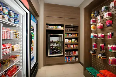 a store aisle with a refrigerator filled with drinks at Residence Inn by Marriott Miami Airport West/Doral in Miami