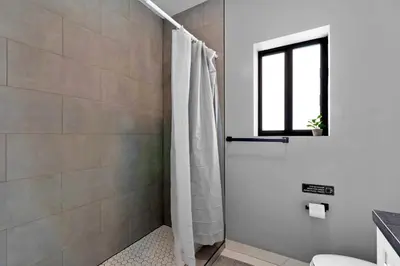 a bathroom with a shower with a shower curtain at Comfortable Townhouse - Free Parking Included in Miami