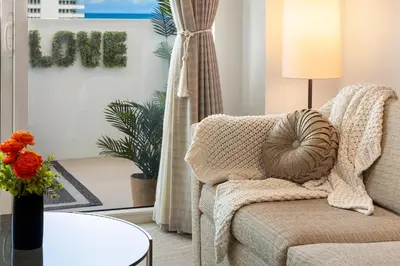 a living room with a couch and a table at Stunning Private Studio at Fontainebleau Sorrento - 802 in Miami Beach