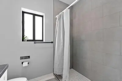 a bathroom with a shower with a shower curtain at Stylish Townhouse Steps from Wynwood in Miami