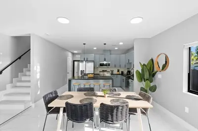 a kitchen and dining room with a table and chairs at Stylish Townhouse Steps from Wynwood in Miami