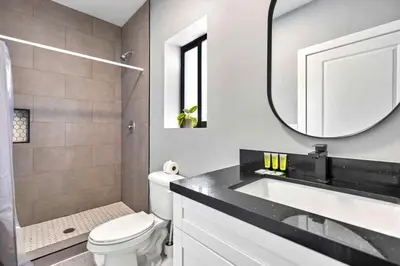 a bathroom with a sink and a toilet and a mirror at Modern Studio Near Wynwood & Design District in Miami