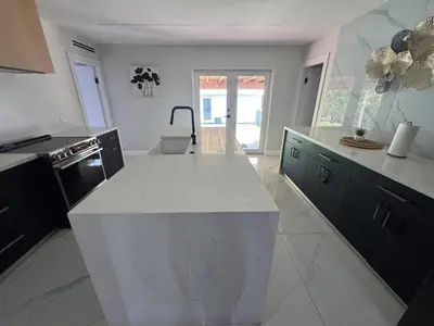 a kitchen with a white counter top in a room at 12 Guest-In The Center of It All in Miami