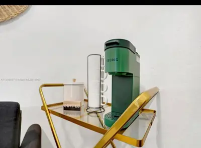 a glass table with a green appliance on top of it at HOT TUB and Washer & Dryer in Unit in Miami