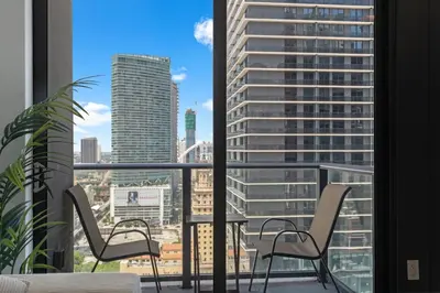 a balcony with chairs and a view of a city at High-Rise Luxury Condo in Downtown Miami with Ocean Views in Miami