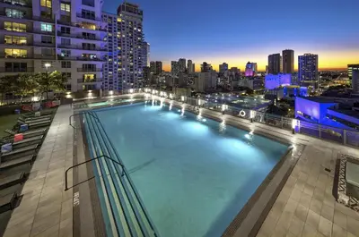 a large swimming pool with a city skyline at night at High-Rise Luxury Condo in Downtown Miami with Ocean Views in Miami