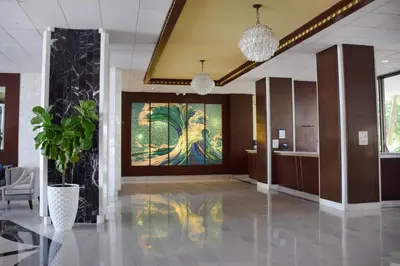 a lobby with a large painting on the wall at Seacoast Suites on Miami Beach in Miami Beach