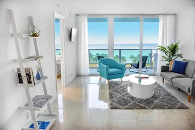 a living room with a view of the ocean at Seacoast Suites on Miami Beach in Miami Beach