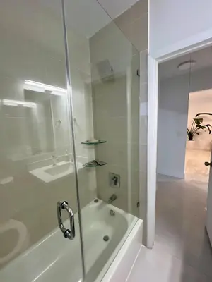a bathroom with a shower and a tub and a sink at North Miami Vacation Home in North Miami Beach
