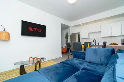 a living room with a blue couch and a table at MetroPark Hotel in Miami