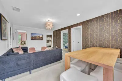 a living room with a blue couch and a wooden table at The Pink Palm Little Havana Pool & Hot Tub in Miami