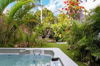 a bath tub in the middle of a garden at The Purple Paradise PoolHot Tub Little Havana in Miami