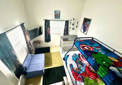 a room with a superhero themed bedroom with a crib at Villa Las Olas Designed with you in mind! in Fort Lauderdale