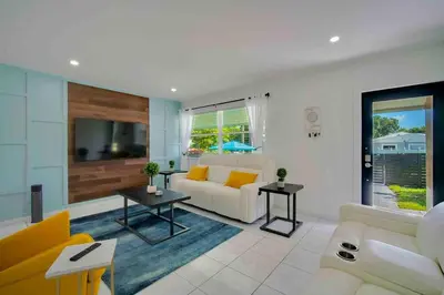 a living room with a couch and a table at Villa Las Olas Designed with you in mind! in Fort Lauderdale