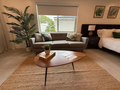 a living room with a couch and a coffee table at The Miami Tropic Suite - Private Stay with Free Parking in the Heart of Miami in Miami