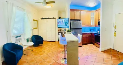 a kitchen with blue chairs and a refrigerator at south beach apartment 5 min walk to the ocean in Miami Beach