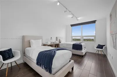 a bedroom with two beds and a window at Midtown Miami Getaway-with pool n parking in Miami