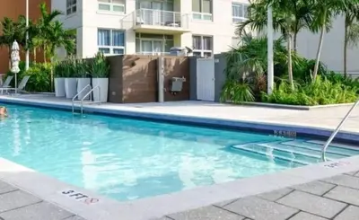 a swimming pool in front of a building at Midtown Miami Getaway-with pool n parking in Miami