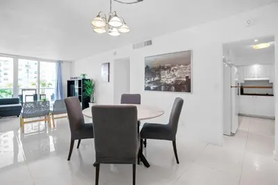 a dining room and living room with a table and chairs at 1BED Condo w/Pool View | 3rd Floor at Tides in Hollywood