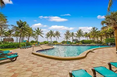 a pool at a resort with palm trees at 1BED Condo w/Pool View | 3rd Floor at Tides in Hollywood