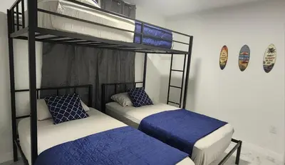 two bunk beds with blue and white sheets in a room at Welcome to Miami! in Miami