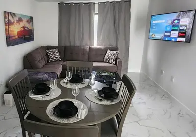 a living room with a table and a couch at Welcome to Miami! in Miami