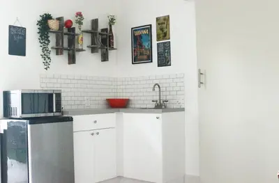 a kitchen with a sink and a microwave at The Havana Nights Guesthouse - Private Stay with Free Parking in the Heart of Miami in Miami