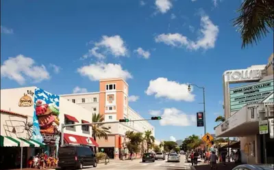 a busy city street with a traffic light and buildings at The Havana Nights Guesthouse - Private Stay with Free Parking in the Heart of Miami in Miami