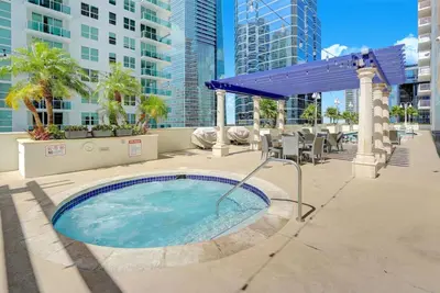 a hot tub in the middle of a patio at Newly Renovated 3BR Condo with Bay Views and Parking in Miami