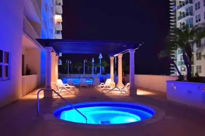 a hot tub in the middle of a patio at night at Newly Renovated 3BR Condo with Bay Views and Parking in Miami