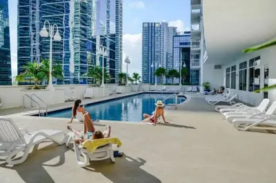 a group of people in the pool at a hotel at Newly Renovated 3BR Condo with Bay Views and Parking in Miami