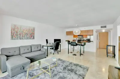 a living room with a couch and a table at Newly Renovated 1BR APT with Pool, Gym, and WFH in Miami