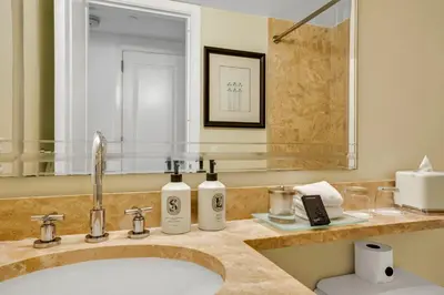 a bathroom with a sink and a mirror at Four Seasons Miami Luxury Two-Bedroom Suite in Brickell - Free Parking in Miami