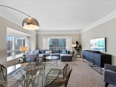 a living room with a couch and a table at Four Seasons Miami Luxury Two-Bedroom Suite in Brickell - Free Parking in Miami