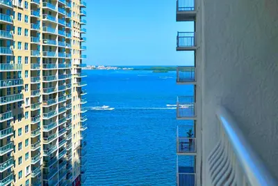 a view of the water between two tall buildings at Comfortable Brickell Studio - City View & Free Parking in Miami