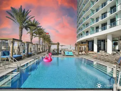 a large swimming pool with a pink inflatable raft at Hollywood Oceanfront Apt in Hollywood
